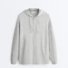 Chaqueta larga con capucha de piqué jaspeado Chaqueta larga con capucha de piqué jaspeado